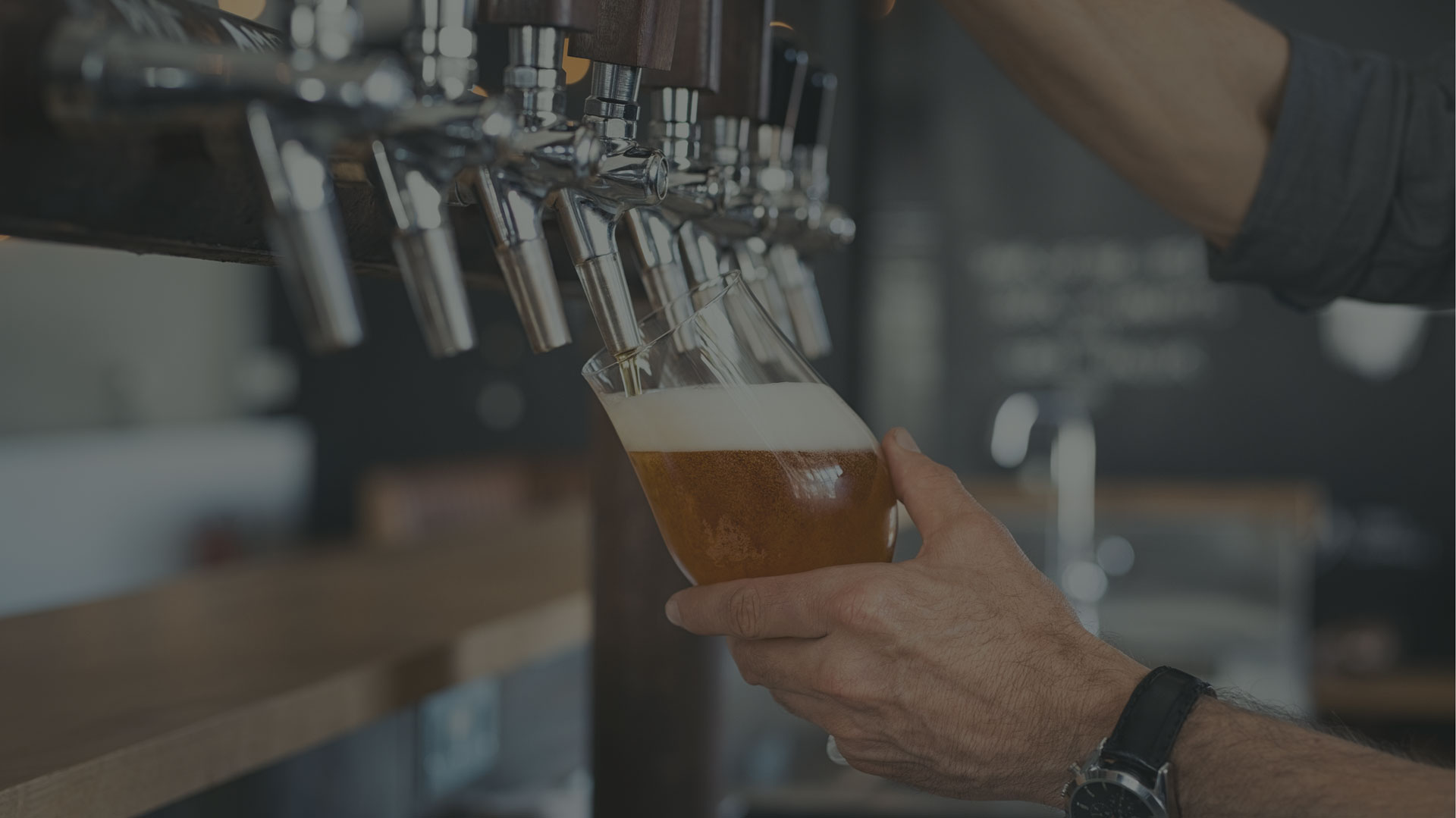 a beer glass being filled from a tap